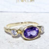 Exquisite, lovely women's oval cut natural amethyst ring set with 2 round cut clear quartz. This ring exudes glamour and the traditional design ensures that it can be worn for many years to come to add a stylish touch to an evening look.