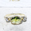 Exquisite, lovely women's oval cut natural peridot ring set with 2 round cut clear quartz.