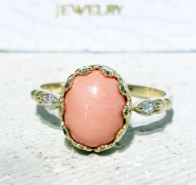 Exquisite, lovely women's oval cut natural coral ring set with 2 marquise cut clear quartz.