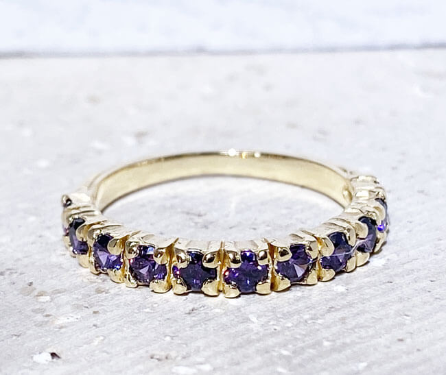 This stylish amethyst half eternity ring is beautifully displayed, the fine craftsmanship shows off the row of purple amethyst, and their stunning sparkle. It's a beautiful gift ring for anybody who loves gemstones.