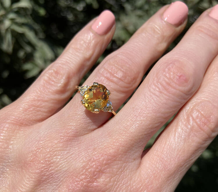 An absolute stunner, classic natural citrine engagement ring with an oval cut gemstone of your choice as it’s centre stone and with round cut clear quartz on the band to further accentuate it.