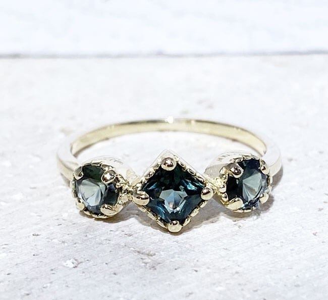 Your loved one will not be able to resist this ravishing handcrafted three-stone ring. The sparkling green tourmaline gemstones give it a truly elegant look.