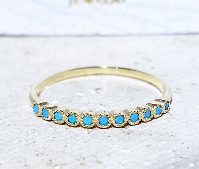 This stylish turquoise half eternity ring is beautifully displayed, the fine craftsmanship shows off the row of blue turquoise, and their stunning sparkle. It's a beautiful gift ring for anybody who loves gemstones.