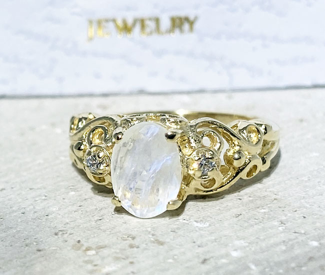 Exquisite, lovely genuine oval cut genuine moonstone ring set with 2 round cut clear quartz.