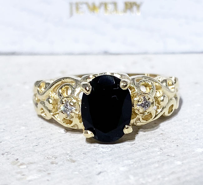 Exquisite, lovely oval cut genuine black onyx ring set with 2 round cut clear quartz.
