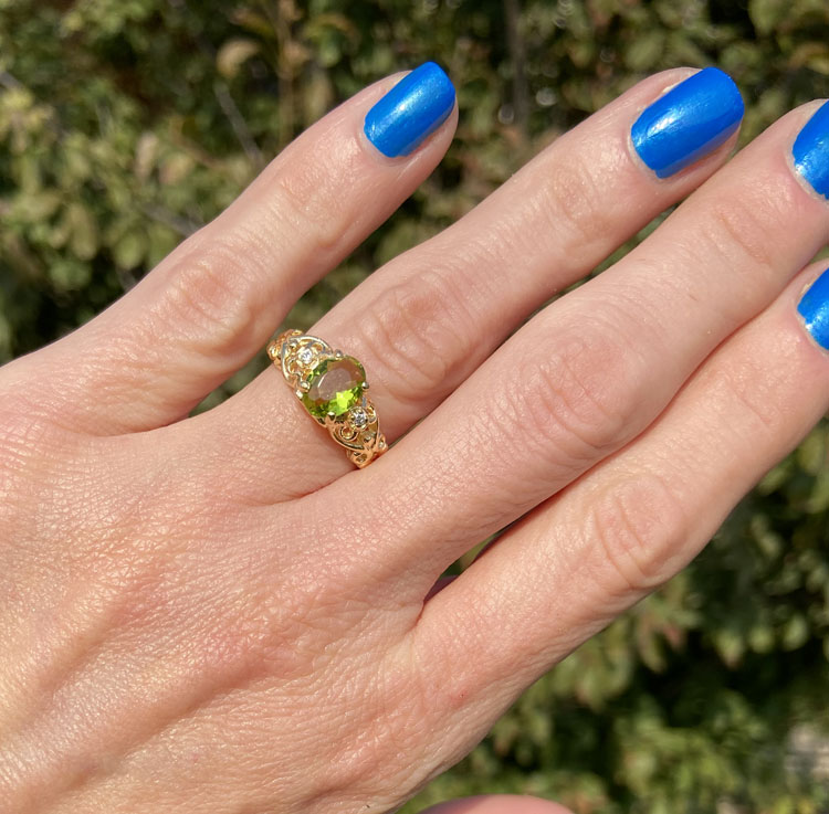 Exquisite, lovely oval cut genuine peridot ring set with 2 round cut clear quartz.