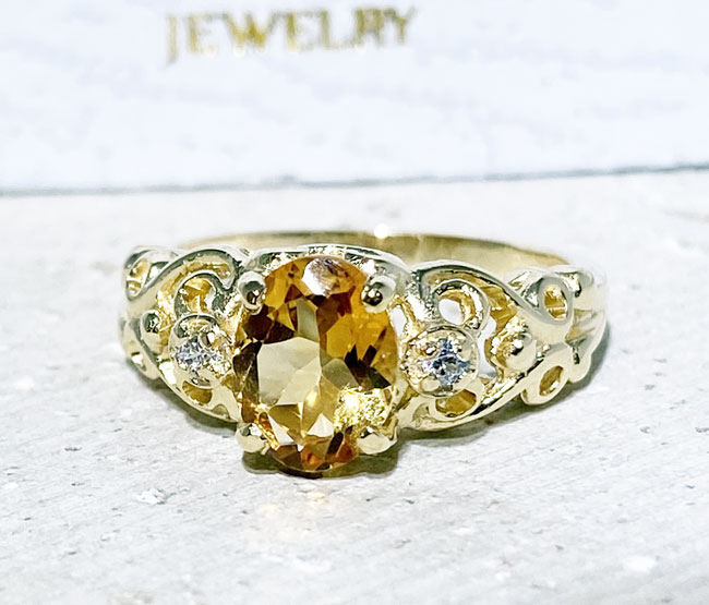 Exquisite, lovely oval cut genuine citrine ring set with 2 round cut clear quartz.