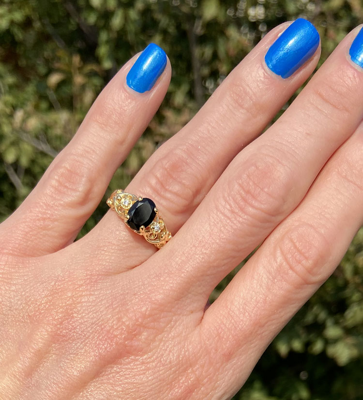 Exquisite, lovely oval cut genuine black onyx ring set with 2 round cut clear quartz.