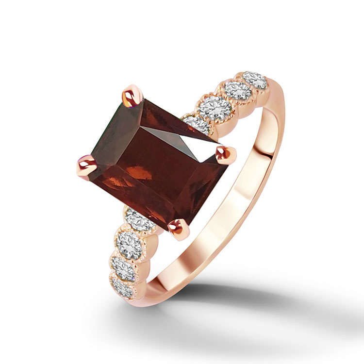 An absolute stunner, classic natural red garnet engagement ring with an emerald cut gemstone of your choice as it’s centre stone and with round cut clear quartz on the band to further accentuate it.