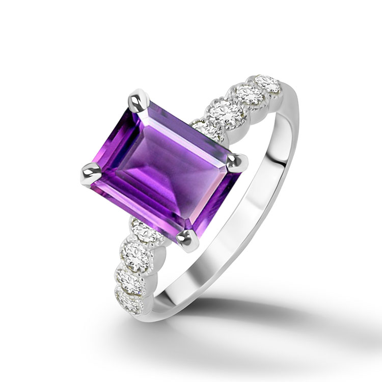 An absolute stunner, classic natural amethyst engagement ring with an emerald cut gemstone of your choice as it’s centre stone and with round cut clear quartz on the band to further accentuate it.