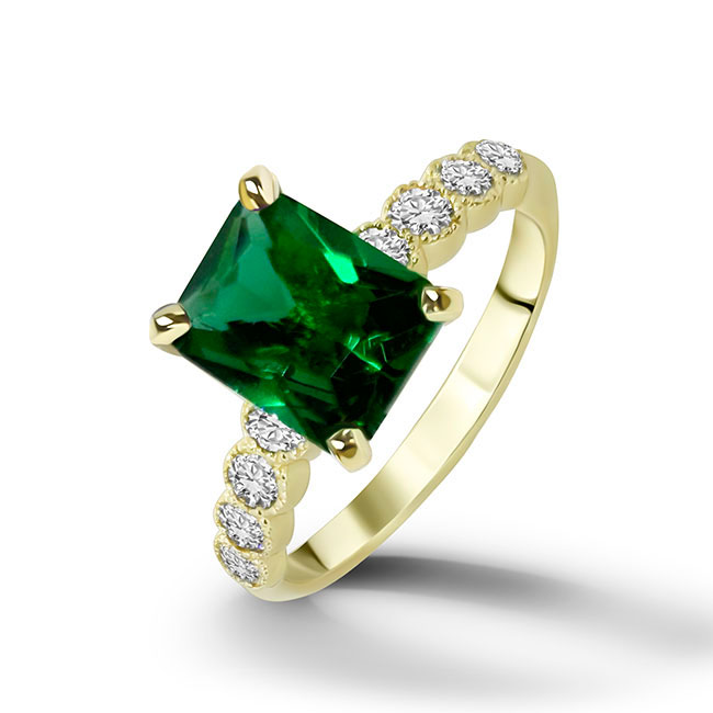 An absolute stunner, classic emerald engagement ring with an emerald cut gemstone of your choice as it’s centre stone and with round cut clear quartz on the band to further accentuate it.