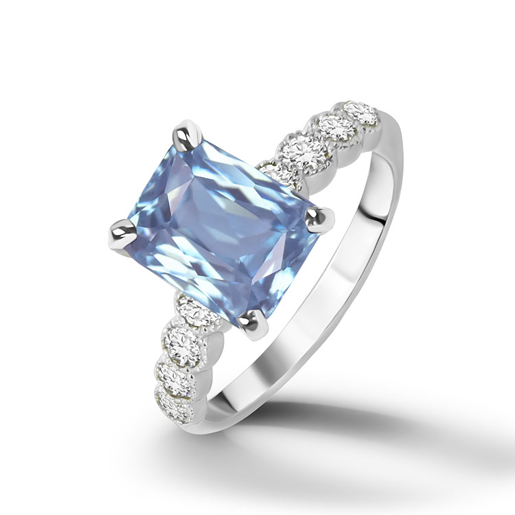 An absolute stunner, classic aquamarine engagement ring with an emerald cut gemstone of your choice as it’s centre stone and with round cut clear quartz on the band to further accentuate it.