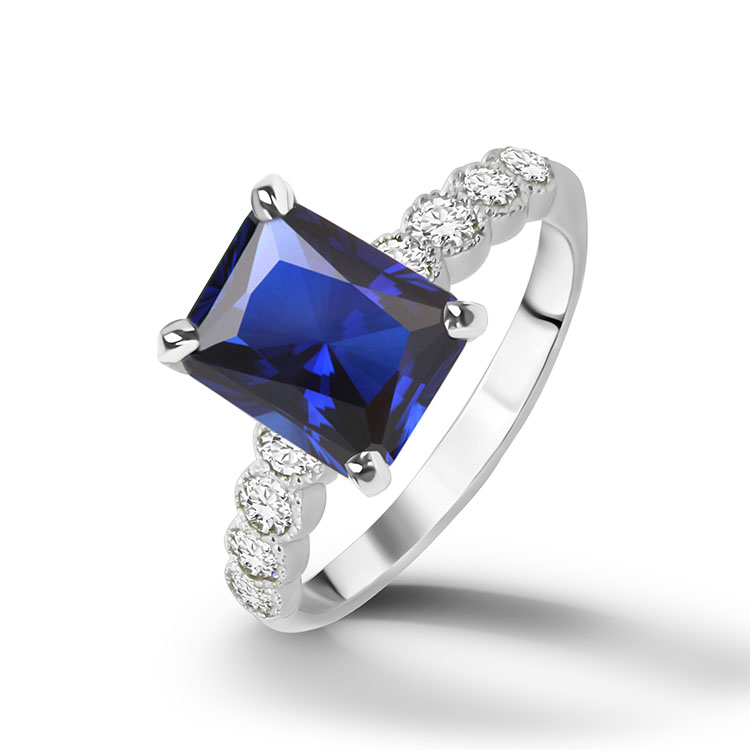 An absolute stunner, classic engagement ring with a blue sapphire gemstone of your choice as it’s centre stone and with round cut clear quartz on the band to further accentuate it.