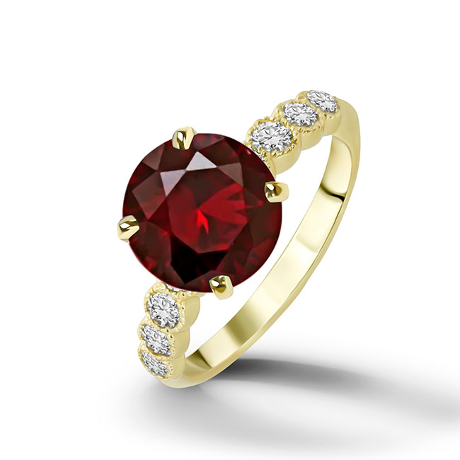 An absolute stunner, classic natural red garnet engagement ring with a round cut gemstone of your choice as it’s centre stone and with round cut clear quartz on the band to further accentuate it.