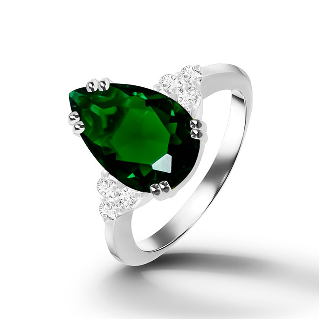 An absolute stunner, classic emerald engagement ring with a pear cut gemstone of your choice as it’s centre stone and with round cut clear quartz on the band to further accentuate it.