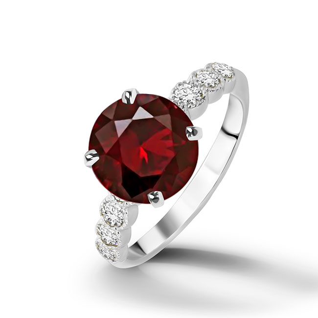 An absolute stunner, classic natural red garnet engagement ring with a round cut gemstone of your choice as it’s centre stone and with round cut clear quartz on the band to further accentuate it.