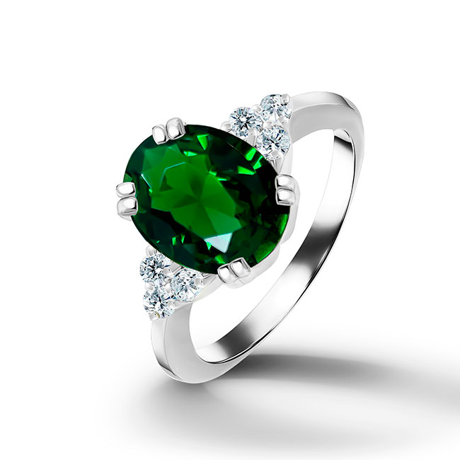 An absolute stunner, classic emerald engagement ring with an oval cut gemstone of your choice as it’s centre stone and with round cut clear quartz on the band to further accentuate it.