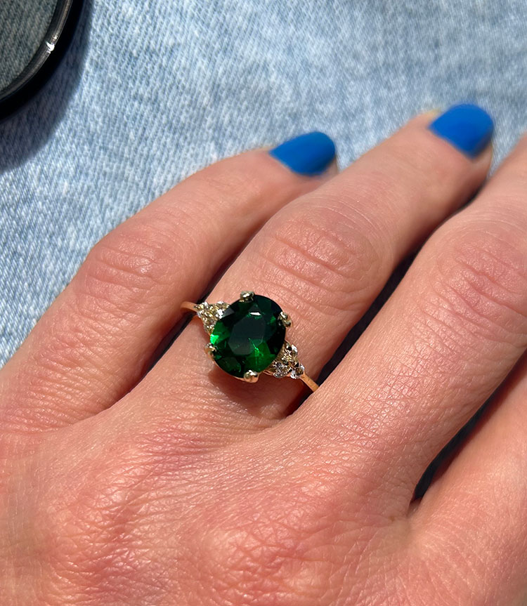 An absolute stunner, classic emerald engagement ring with an oval cut gemstone of your choice as it’s centre stone and with round cut clear quartz on the band to further accentuate it.